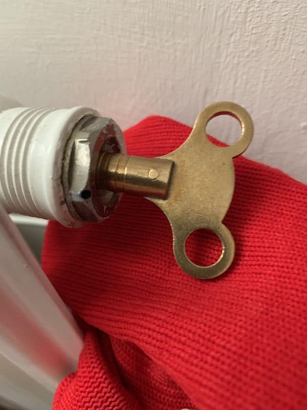 Bleeding a radiator to remove trapped air and improve heating performance